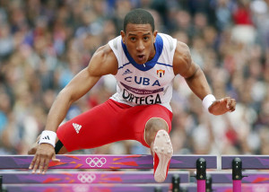 Cuba's Orlando Ortega clears a hurdle on his way to take first place in his men's 110m hurdles round 1 heat at the London 2012 Olympic Games at the Olympic Stadium