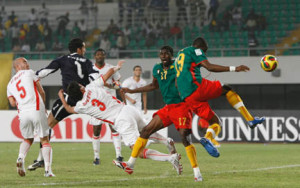 Stephane Mbia of Cameroon gets his shot away to score during their quarter-final match against Tunisia at the African Nations Cup soccer tournament in Tamale