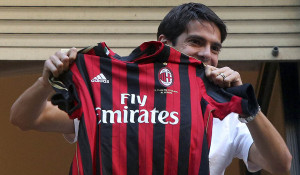 Brazilian player Kaka holds up an AC Milan jersey after arriving in Milan