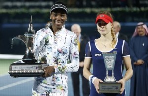 First-placed Williams of the U.S. and second-placed Cornet of Franceh hold their trophies after their women's singles final match at the Dubai Tennis Championships