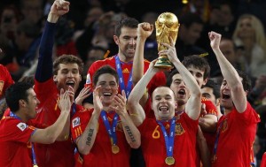 Spain's Iniesta holds the World Cup trophy after the 2010 World Cup final soccer match between Netherlands and Spain at Soccer City stadium in Johannesburg