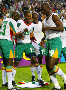 Senegal team mates, Lamine Diatta (L), Salif Diao (C), Khalilou Fadiga (R Rear) dance on Papa Bouba ..