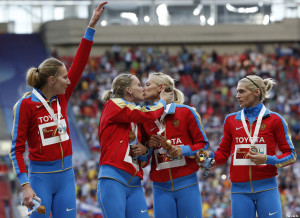 Gold medallists team Russia celebrate at the women's 4x400 metres relay victory ceremony during the IAAF World Athletics Championships at the Luzhniki stadium in Moscow