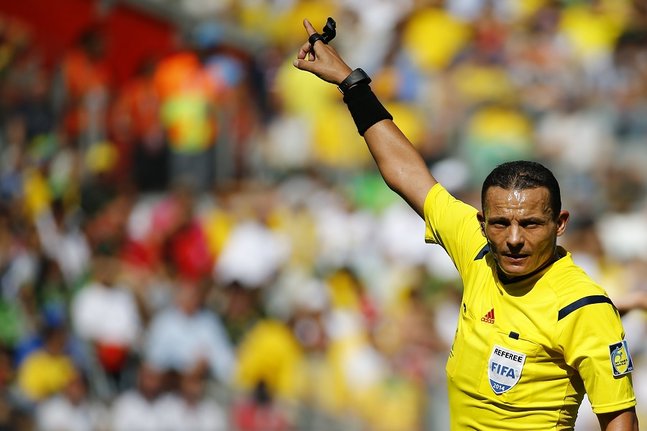 Referee Haimoudi of Algeria gestures during the 2014 World Cup Group D soccer match between England and Costa Rica at the Mineirao stadium in Belo Horizonte