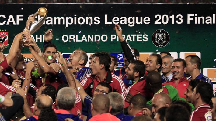 Egypt's Al Ahli players celebrate with the trophy after winning their African Champions League final soccer match against South Africa's Orlando Pirates in Cairo