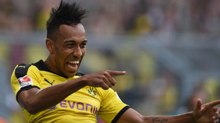 Dortmund's Gabonese striker Pierre-Emerick Aubameyang celebrates scoring during the German first division Bundesliga football match Borussia Dortmund vs Borussia Moenchengladbach in Dortmund, western Germany, on August 15, 2015. AFP PHOTO / PATRIK STOLLARZ..RESTRICTIONS: DURING MATCH TIME: DFL RULES TO LIMIT THE ONLINE USAGE TO 15 PICTURES PER MATCH AND FORBID IMAGE SEQUENCES TO SIMULATE VIDEO. .== RESTRICTED TO EDITORIAL USE ==.FOR FURTHER QUERIES PLEASE CONTACT DFL DIRECTLY AT + 49 69 650050. (Photo credit should read PATRIK STOLLARZ/AFP/Getty Images)