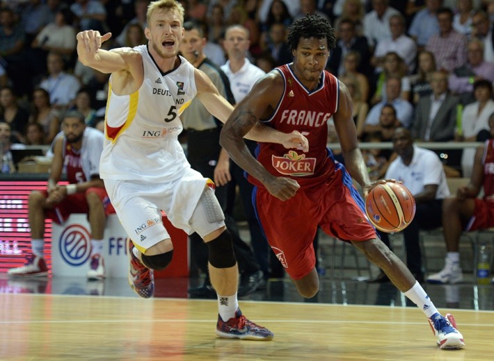 France's Mickael Gelabale (R) vies for the ball against Germany's Niels Giffey, during a friendly match between France and Germany, at the Rhenus hall in Strasbourg on August 28, 2015, ahead of the FIBA EuroBasket 2015 championship. AFP PHOTO / PATRICK HERTZOG