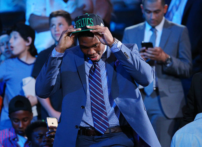 Jun 23, 2016; New York, NY, USA; Guerschon Yabusele puts on a team cap after being selected as the number sixteen overall pick to the Boston Celtics in the first round of the 2016 NBA Draft at Barclays Center. Mandatory Credit: Brad Penner-USA TODAY Sports