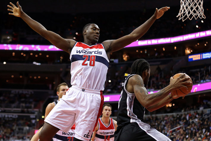 Nov 26, 2016; Washington, DC, USA; San Antonio Spurs forward Kawhi Leonard (2) leaps to pass the ball as Washington Wizards center Ian Mahinmi (28) defends in the fourth quarter at Verizon Center. The Spurs won 112-100. Mandatory Credit: Geoff Burke-USA TODAY Sports